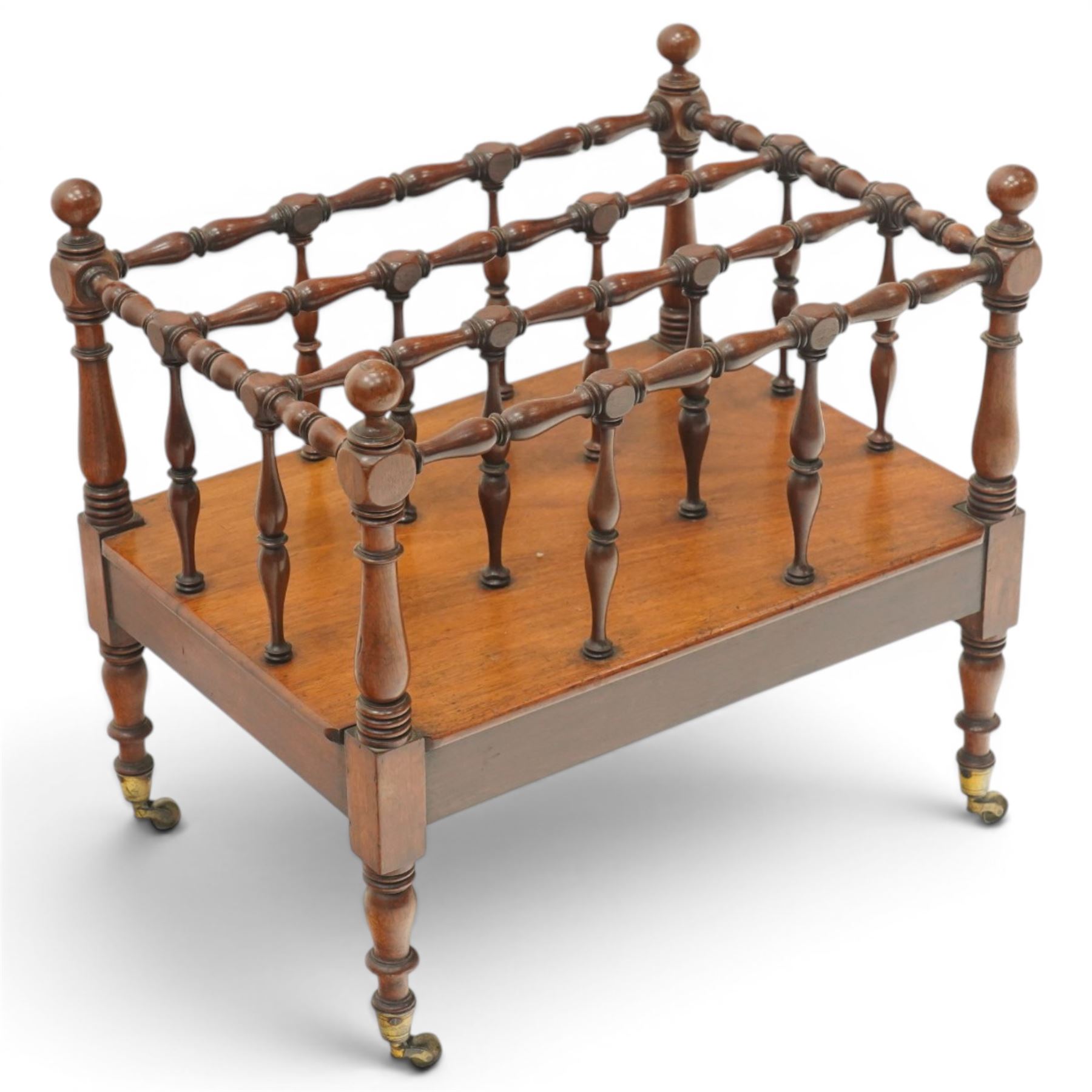 Victorian mahogany canterbury, four division top with bobbin turned rails and spindle uprights, rectangular base with moulded edge, on turned corner supports with brass castors