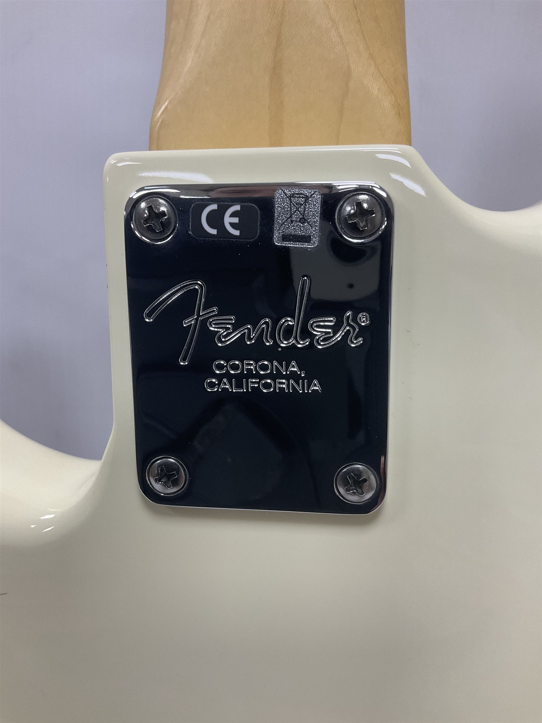 Fender Precision Bass guitar, in Olympic White finish with tortoiseshell effect scratchboard, serial no US15103092, in black Fender hard case with Fender strap and warranty card, guitar L116cm