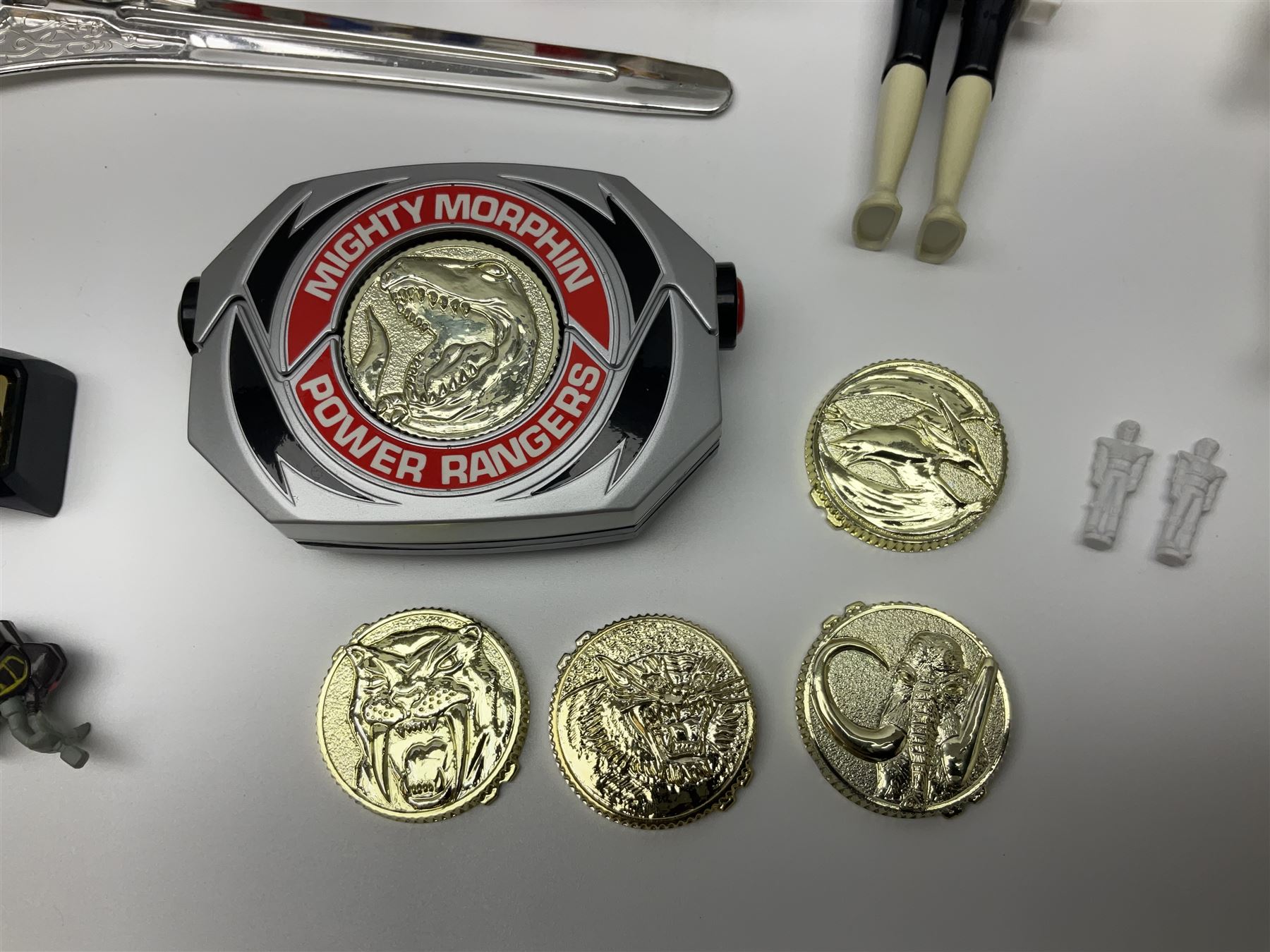 Collection of early 90s Mighty Morphin’ Power Rangers Zords, figures and accessories. Titanus the Carrier Zord, marked Bandai 1991; Green Dragonzord, incomplete; 1994 White Tigerzord with original instruction manual; 1993 Triceratops Dinozord, Mastodon Dinozord and Sabertooth Tiger Dinozord, Pterodactyl Dinozord, missing guns; with 1993 Power Morpher and original Power Coins, with further related figures, accessories and weapons