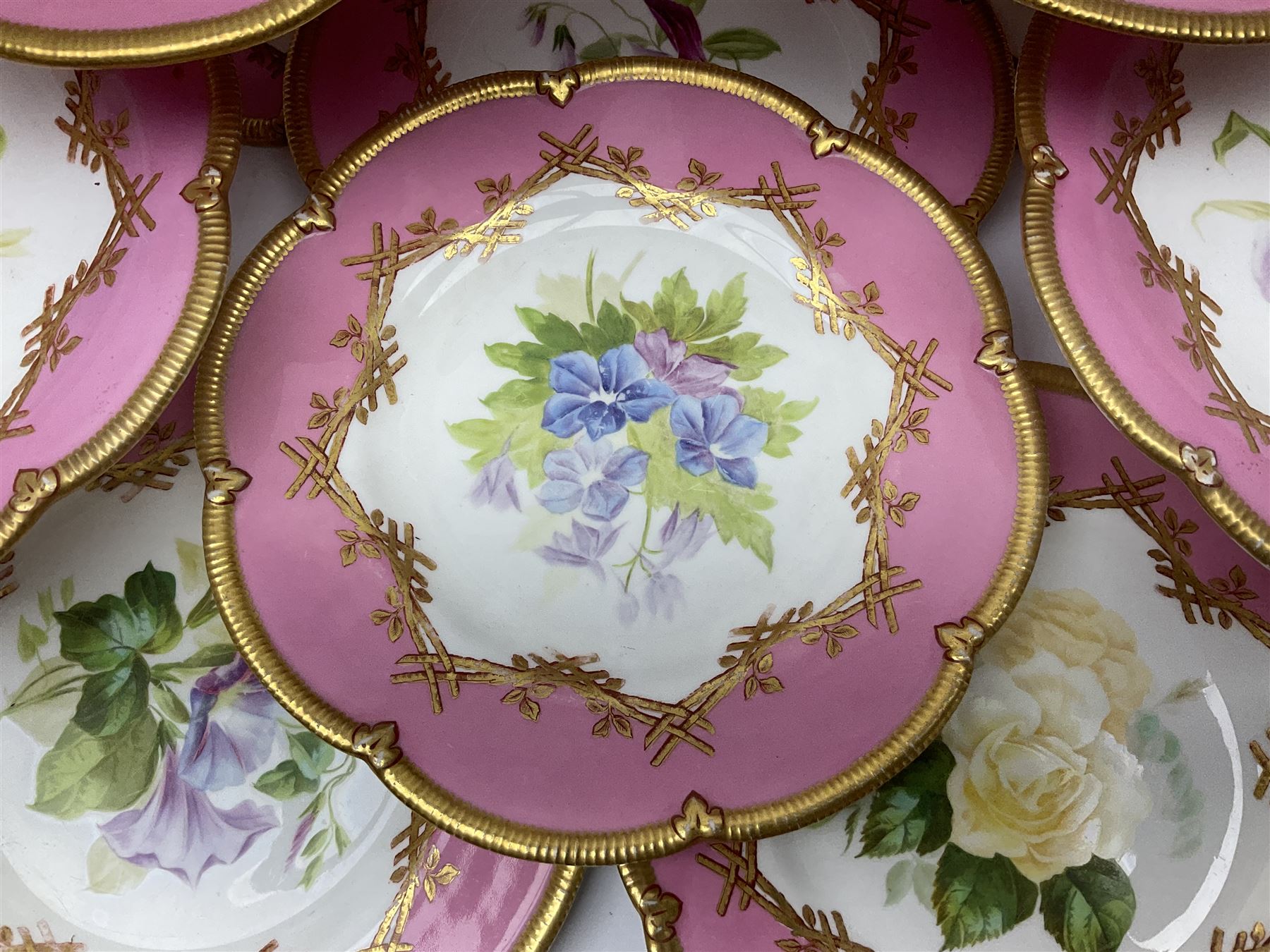 Victorian dessert service, comprising four comports and nine plates, each decorated with floral sprigs to the centre with a pink and gilt border, largest comport H13cm, plate D22.5cm