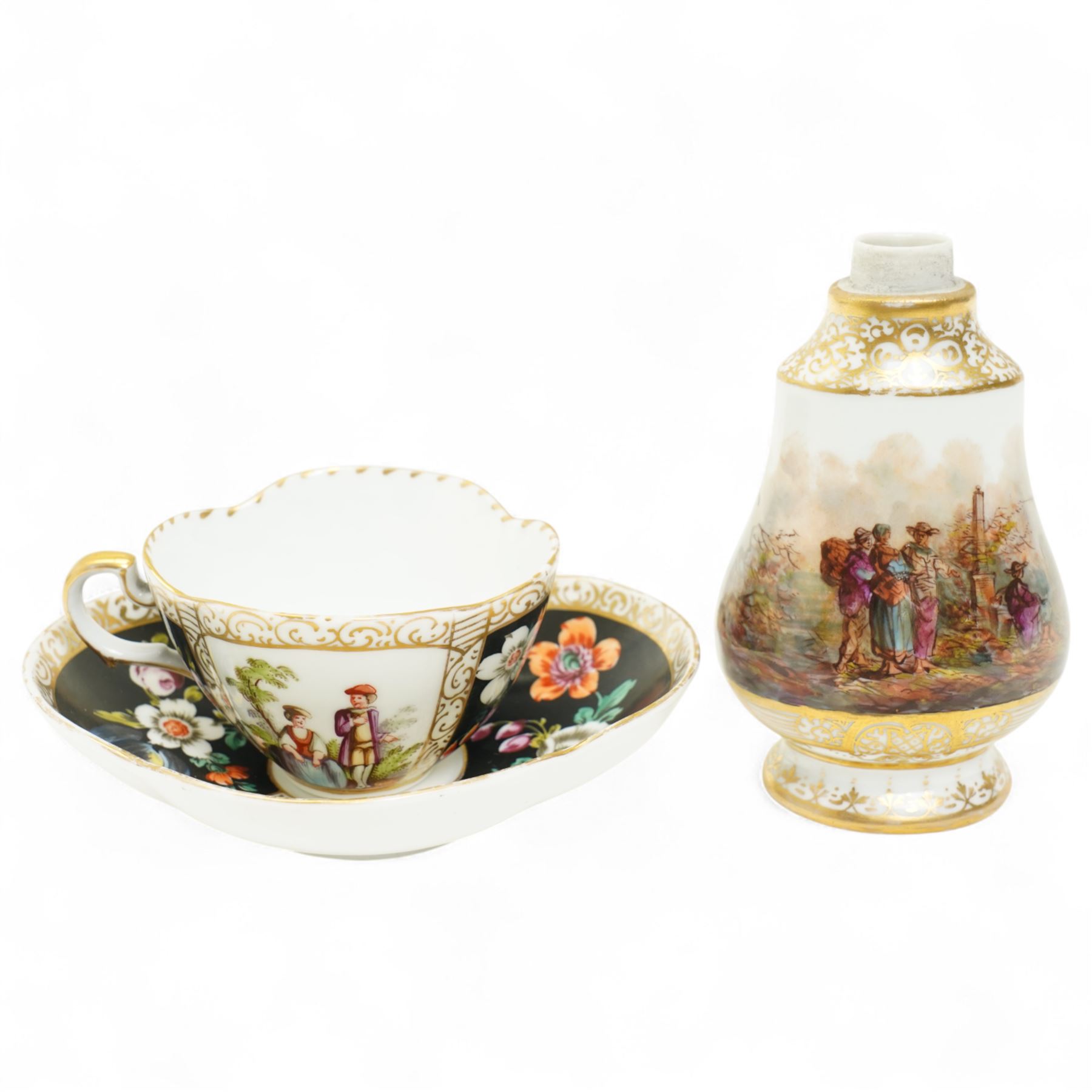 Helena Wolfsohn Dresden porcelain quatrefoil teacup and saucer, decorated with panels of figures and floral sprays on a black ground, marked to base, together with a flask with painted scene of travellers in a port, indistinct continental mark to base, flask H12cm