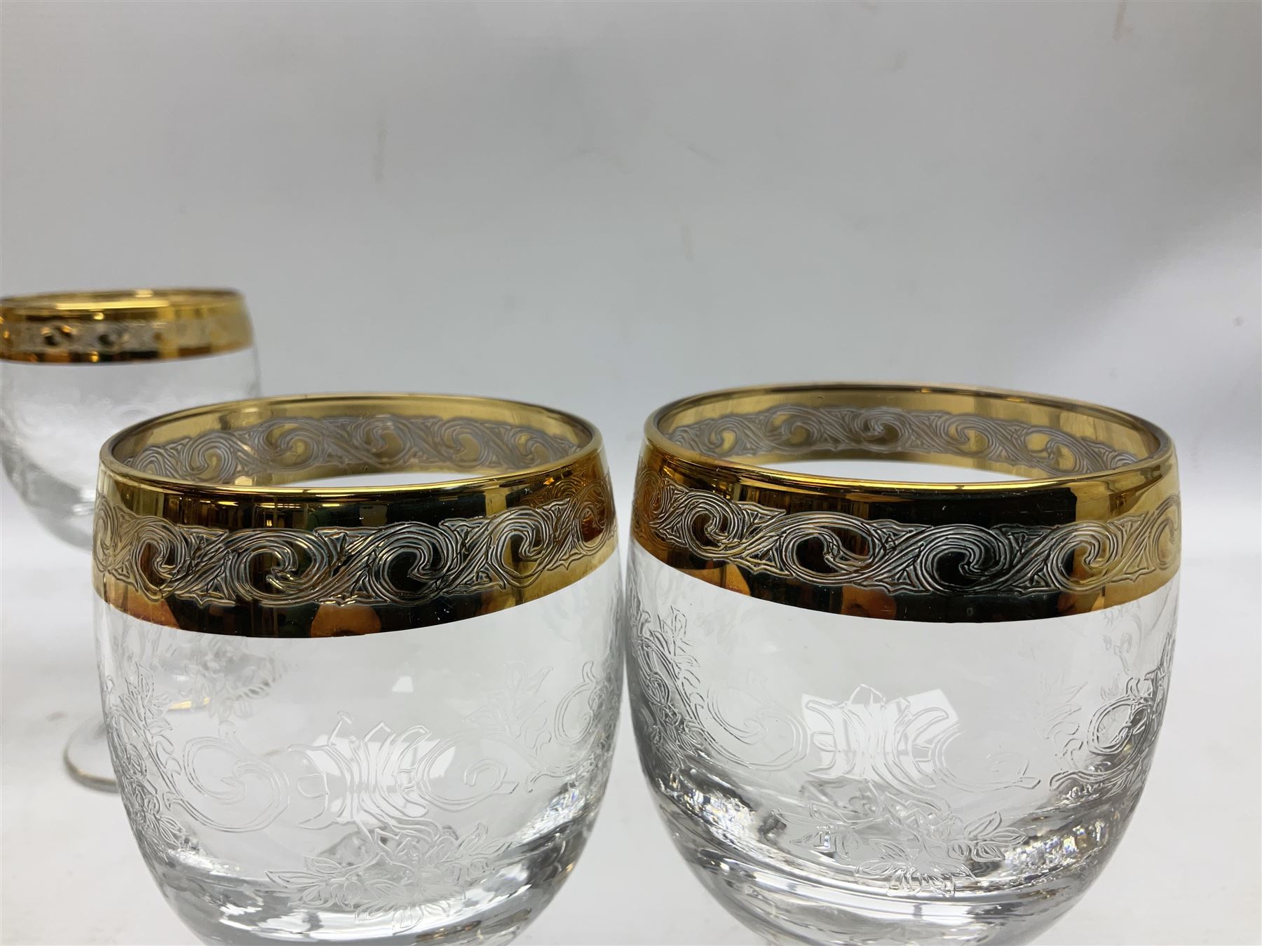 Set of twelve Moser style wine glasses, the bowls with etched floral bodies and gold banded rim with foliate decoration raised upon stem of twisted form, H14cm