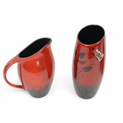 Two Poole Pottery vases decorated in Butterfly pattern, together with matching jug and another Poole Pottery vase decorated in cherry blossom
