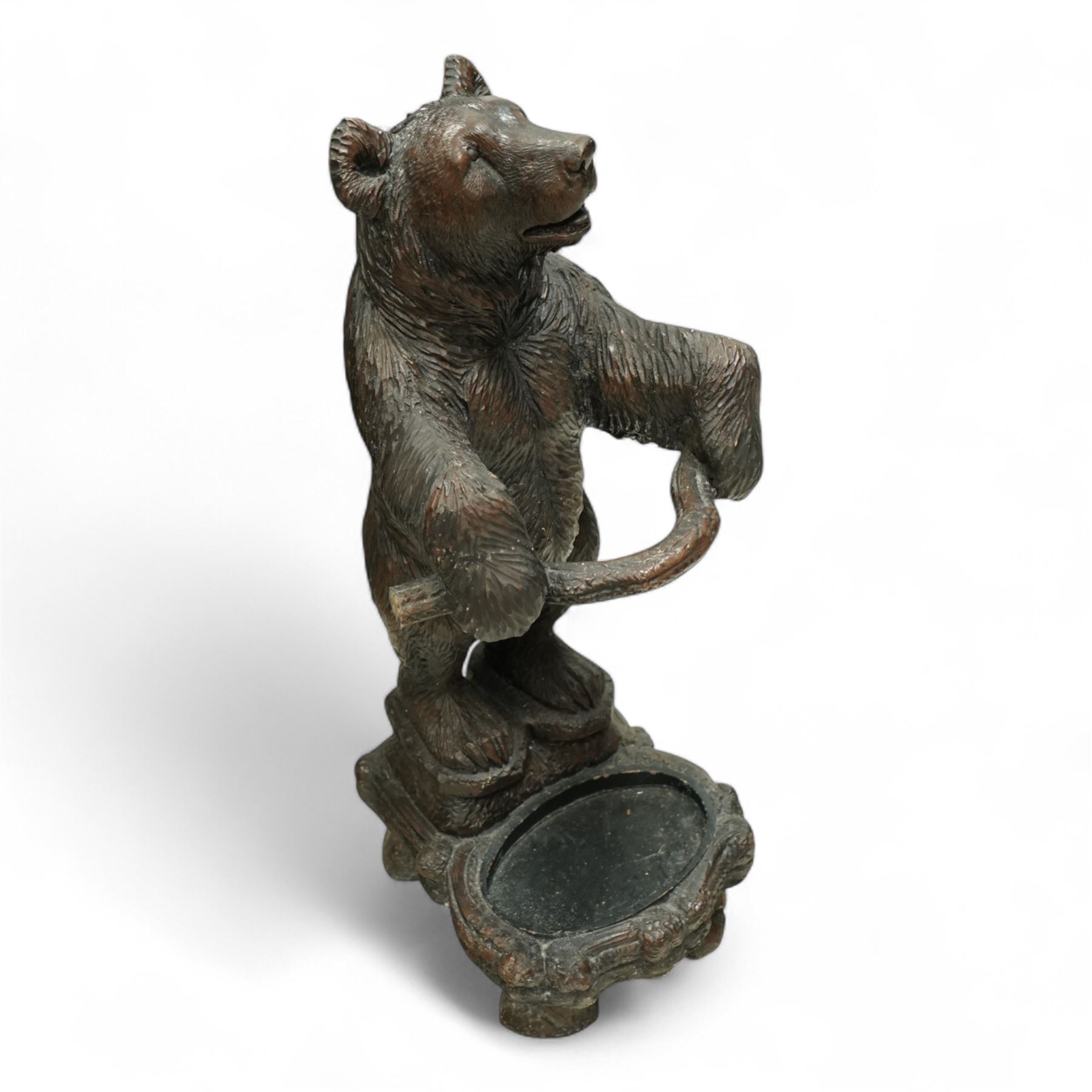 Early 20th century Black forest bear design stick stand, composite wood model of a bear with arms outstretched holding a branch forming the stick stand above a drip tray on tree branch form feet 