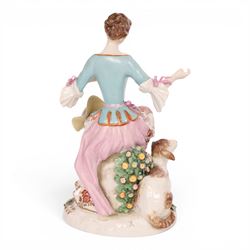 Pair of 19th century Samson figures, the gentleman wearing a wide brimmed hat with a dog, the lady with a sheep by her side, both figures seated upon a floral encrusted pillars with gilt scrolling base, H22cm