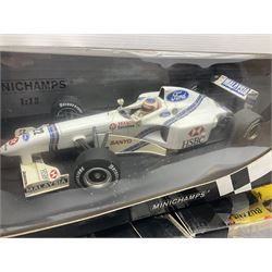 Three Minichamps 1:18 scale die-cast racing cars - Jordan Mugen Honda 198 D. Hill; Jordan Ford EJ13 G. Fisichella; and Stewart Ford SF 1 R. Barrichello; all boxed (3)