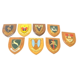 A group of eight wooden Military and School plaques, comprising King's African Rifles, Kenya Regiment, University of South African, Kampala RUFC, Uganda Rugby Football Union, St Martin's School, Nawton, Mount Carmel School, and an example with Latin inscription Vis Virtus Veritas. 