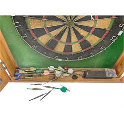 Dart board in wooden cabinet
