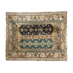 Small Persian red and blue ground rug (115cm x 88cm); and a Persian beige ground rug with two elongated medallions (162cm x 132cm)