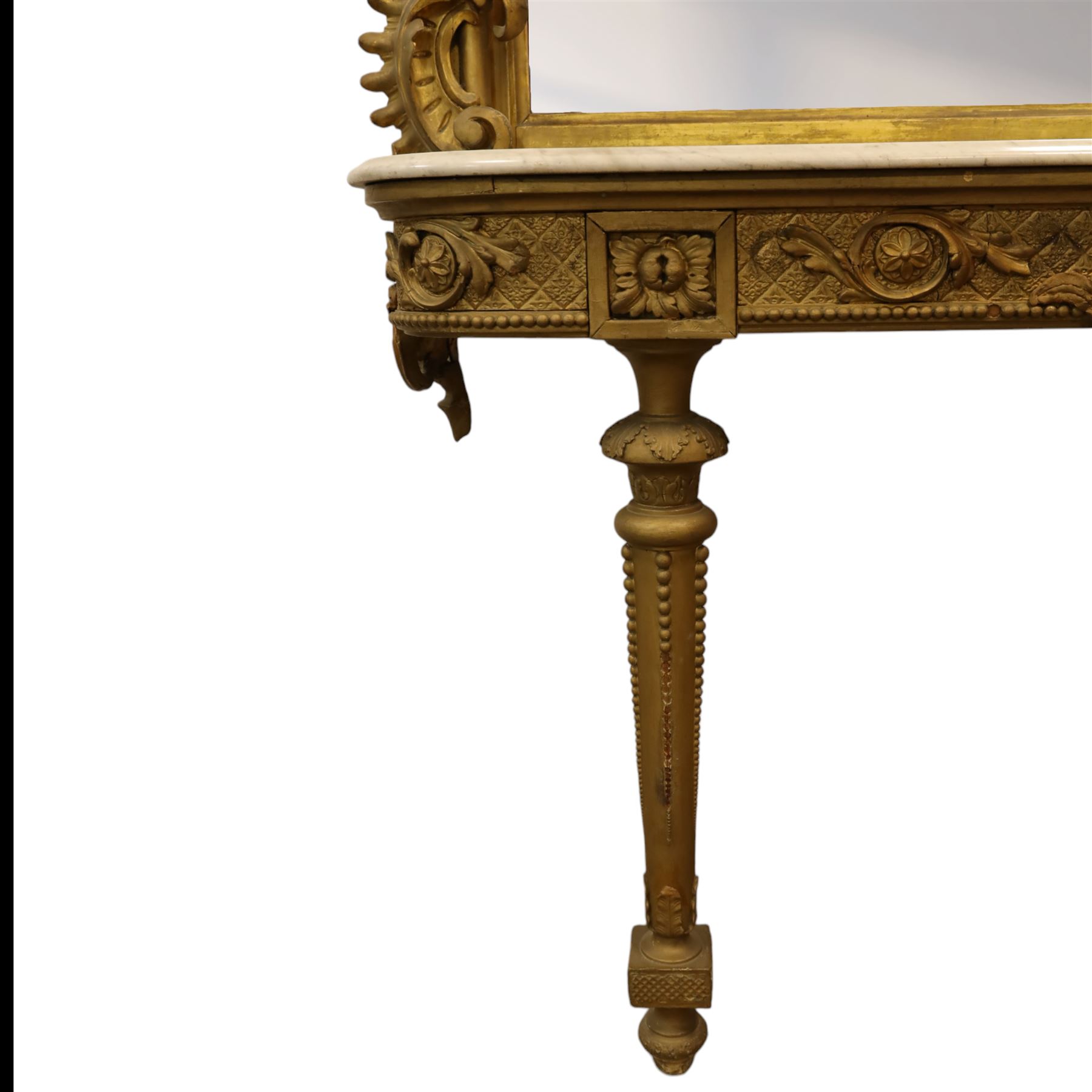 Large late 19th century Rococo revival giltwood and gesso pier mirror, the rounded rectangular frame with richly carved crest and scrolls with acanthus leaves and foliate ornamentation, above a giltwood console table with Carrara marble top and richly carved guilloche and ribbon tied laurel garland frieze, rosettes, and central scrollwork, raised upon tapered legs with beaded moulding and square block above with turned toupie style terminal  