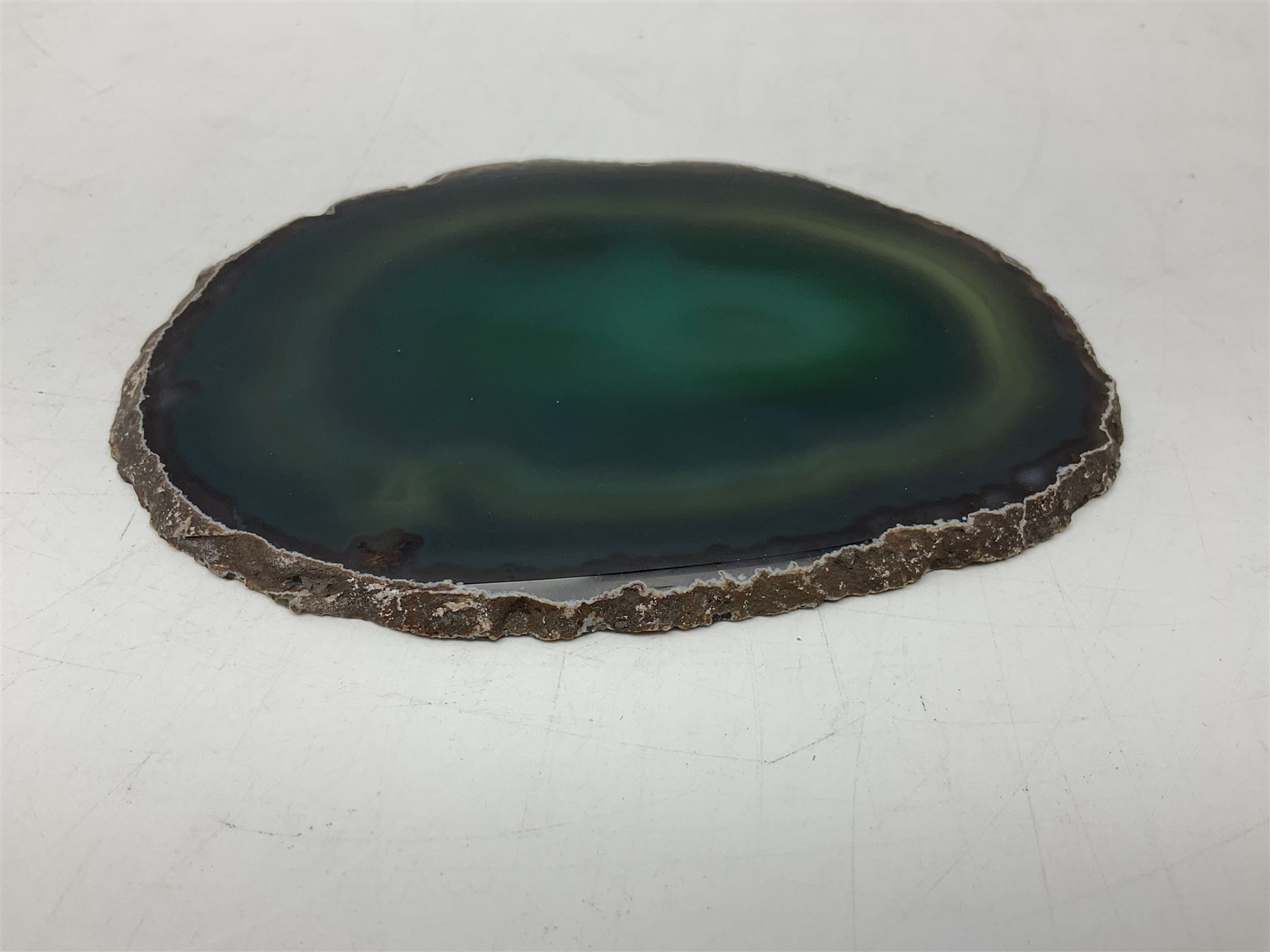 Pair of green agate slices, polished with rough edges raised upon silvered metal stands, H19cm