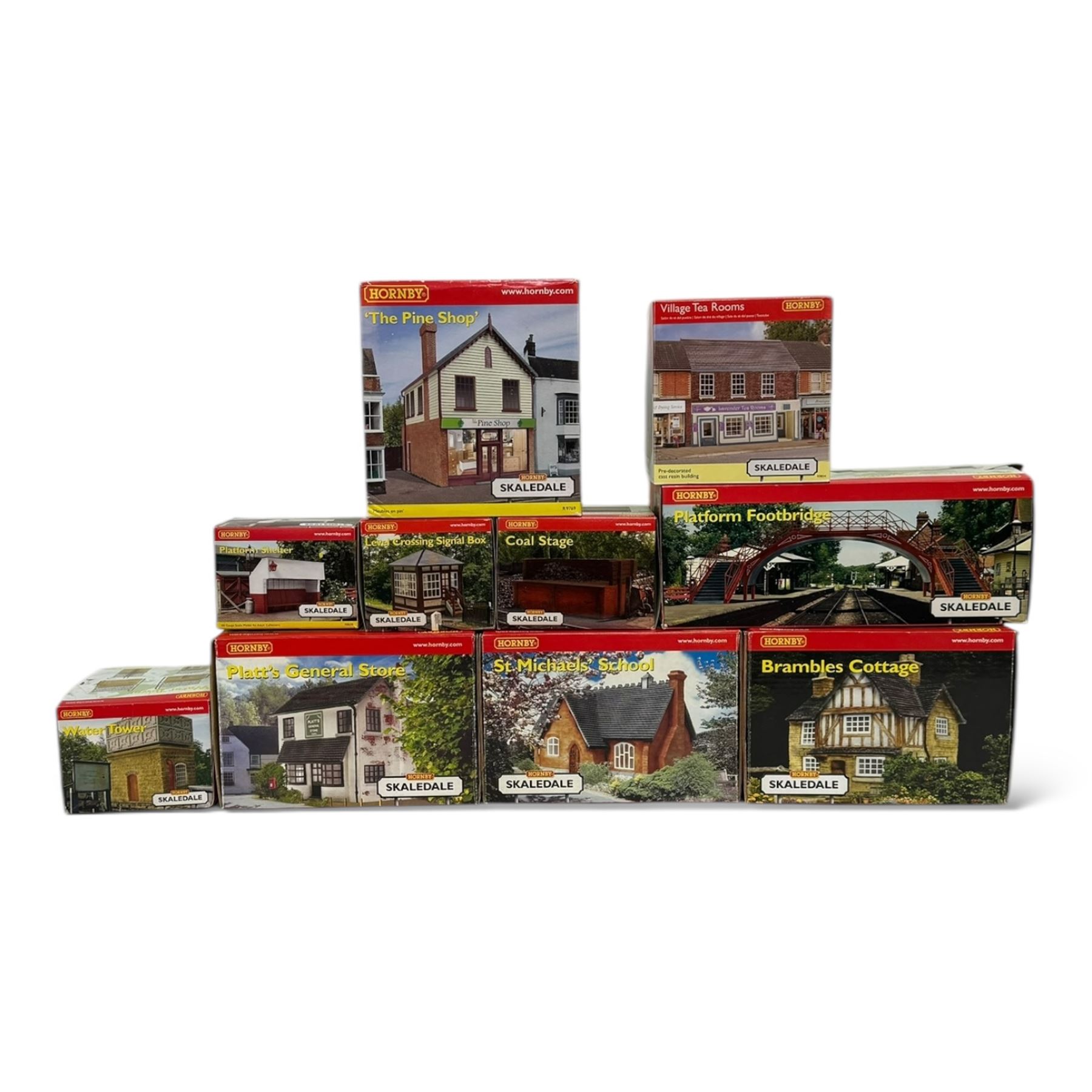Ten Hornby '00' gauge Skaledale buildings, comprising R9834 Village Tea Rooms, R8506 Brambles Cottage, R8507 Platt's General Store, R8503 St Michaels School, R9769 The Pine Shop, R8641 Platform Footbridge, R8639 Water Tower, R8587 Coal Stage, R8589 Level Crossing Signal Box and R8638 Platform Shelter, all boxed
