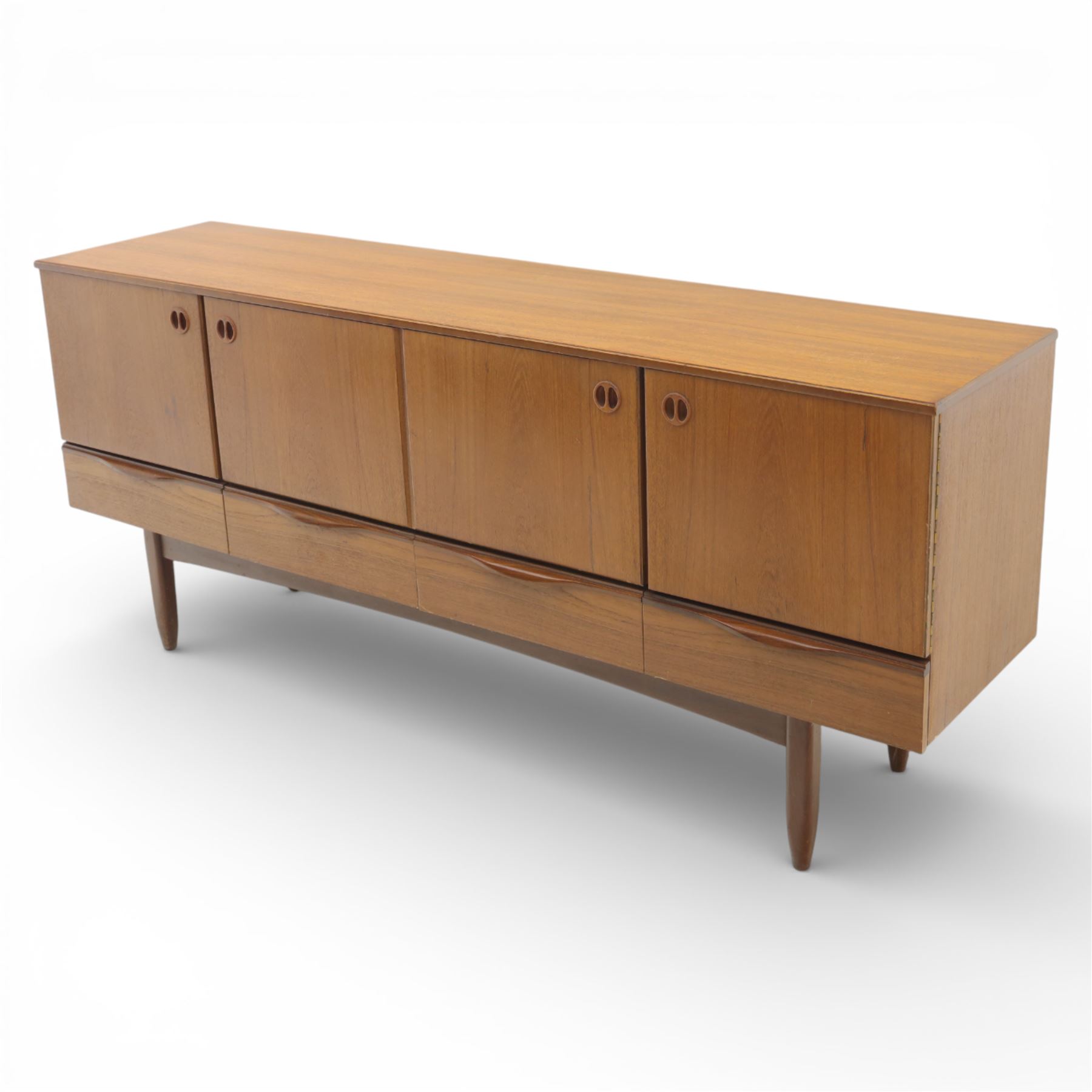 Portwood - Mid 20th century teak sideboard, rectangular top with fall front in the centre flanked by cupboard doors with recessed handles, above four drawers raised on tapered legs