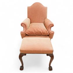 William & Mary design walnut framed armchair, arched cresting rail over rolled arms and C-scrolled arm supports, upholstered in peach herringbone fabric with contrasting rouge twist piping, on turned front feet with scrolled terminals, united by shaped and moulded X-frame stretchers with turned finial (W80cm, H106cm, D80cm); together with a Georgian design mahogany footstool, in matching upholstery with stud band, on acanthus leaf carved cabriole supports with ball and claw feet (60cm x 47cm, H47cm)