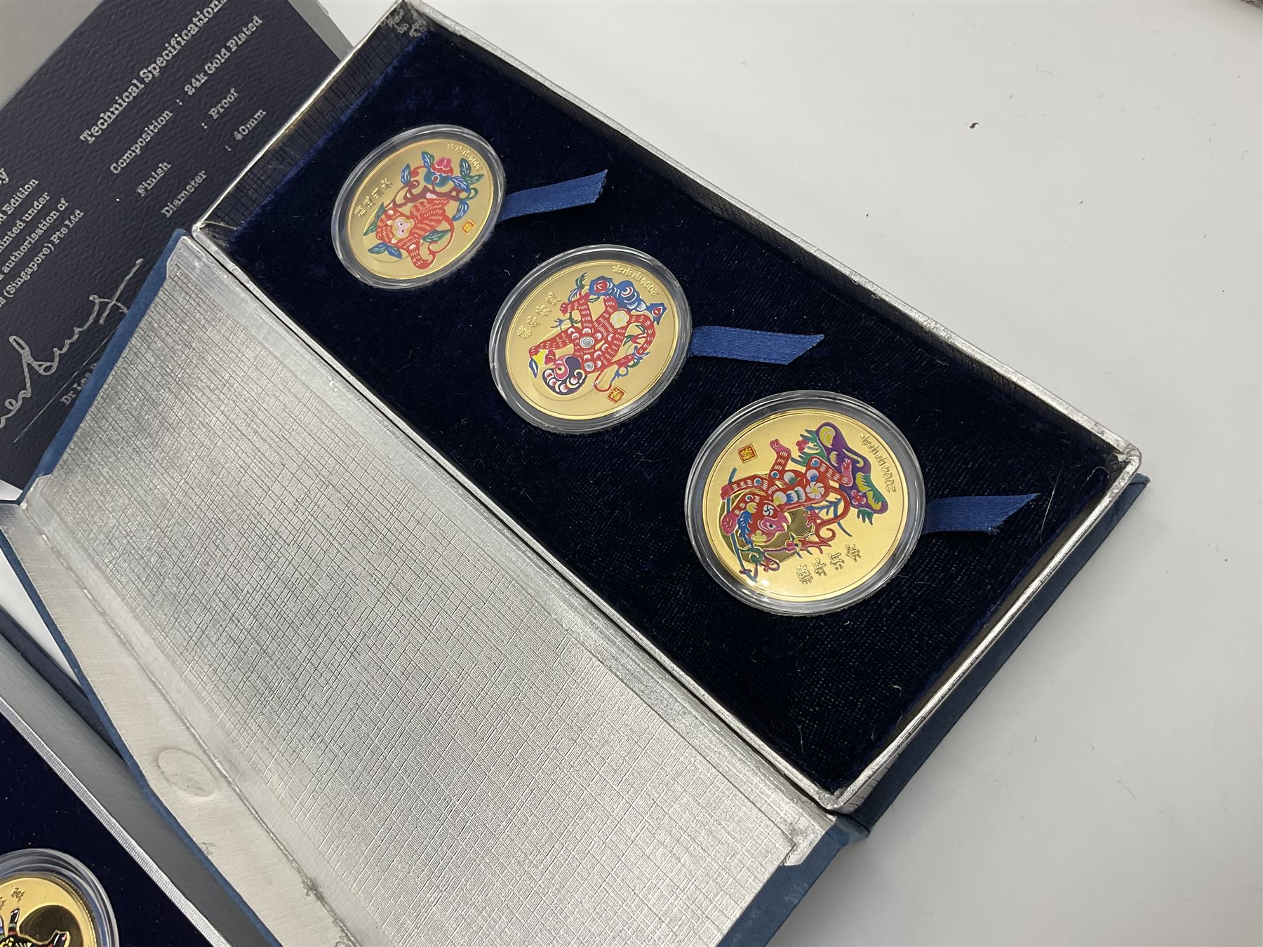 Singapore Venhonia commemorative medallion collection and a Tiger Beer commemorative three-medallion collection, both cased with certificates