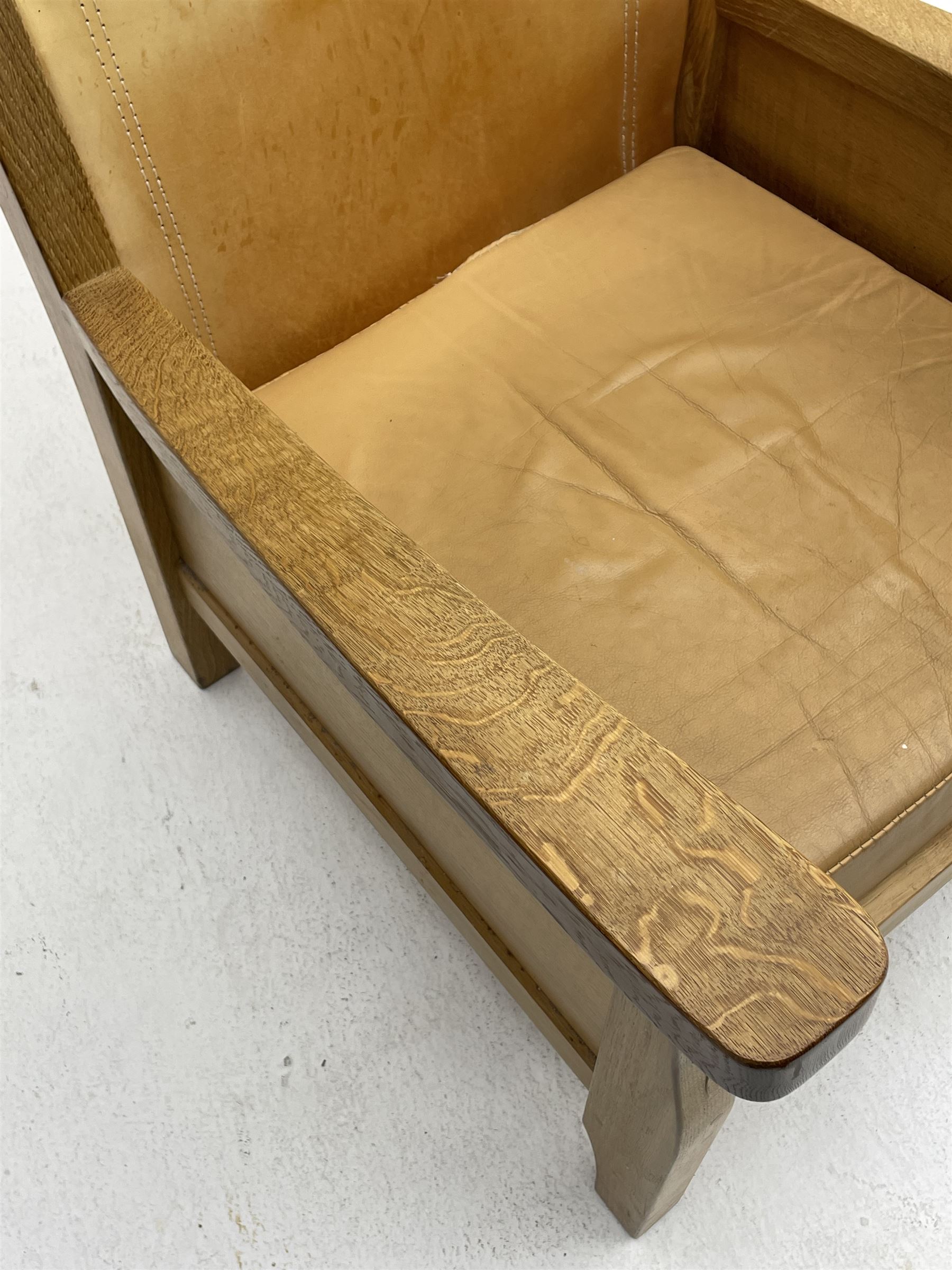 'Mouseman' oak smokers armchair, panelled sides, slung tan leather back and upholstered seat cushion, by Robert Thompson of Kilburn