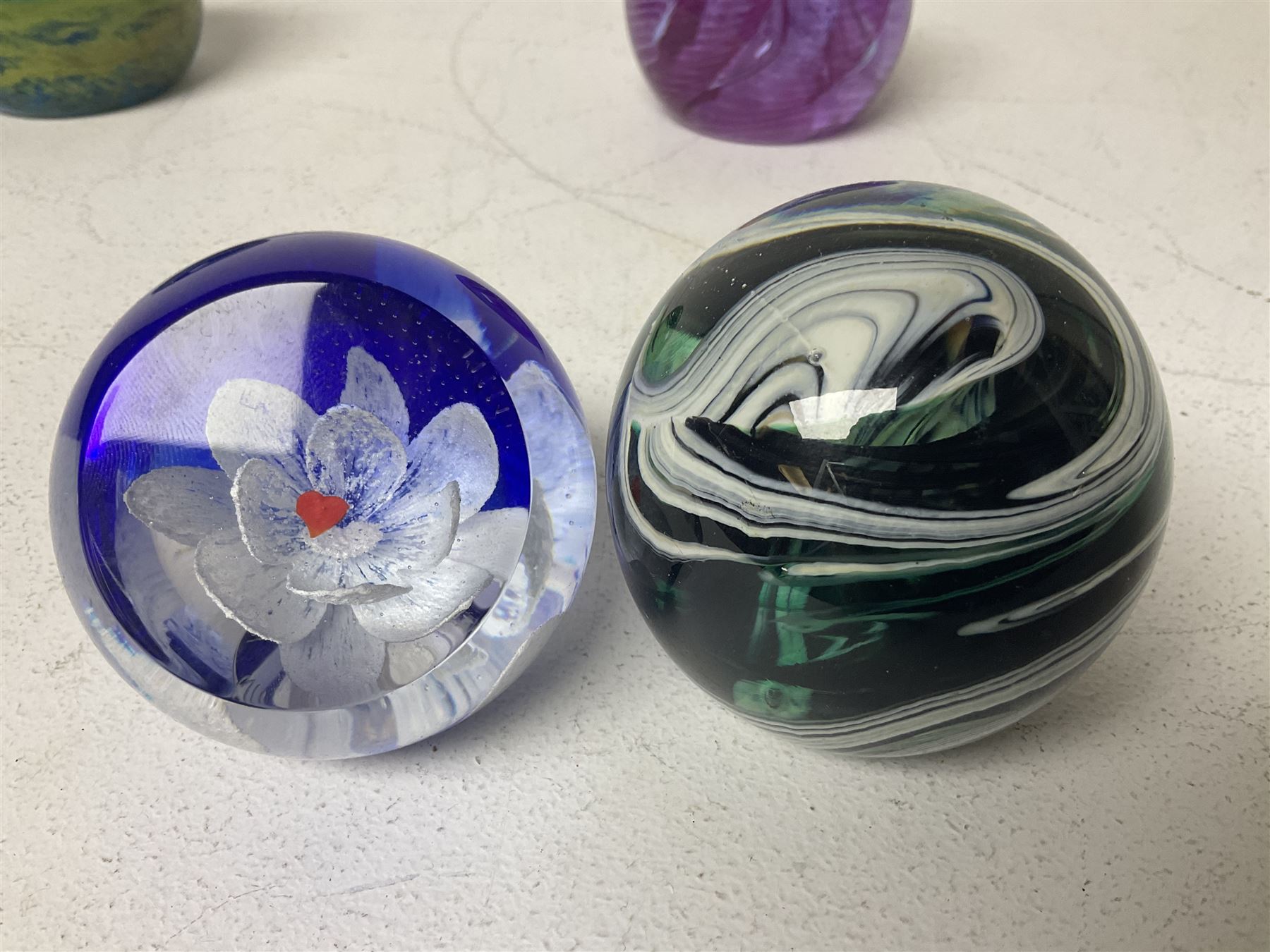 Twelve Caithness glass paperweights, to include Pastel, Mooncrystal and Fiesta, together with Baccarat 'The Princess Anne' paperweight and two Mdina examples (15)