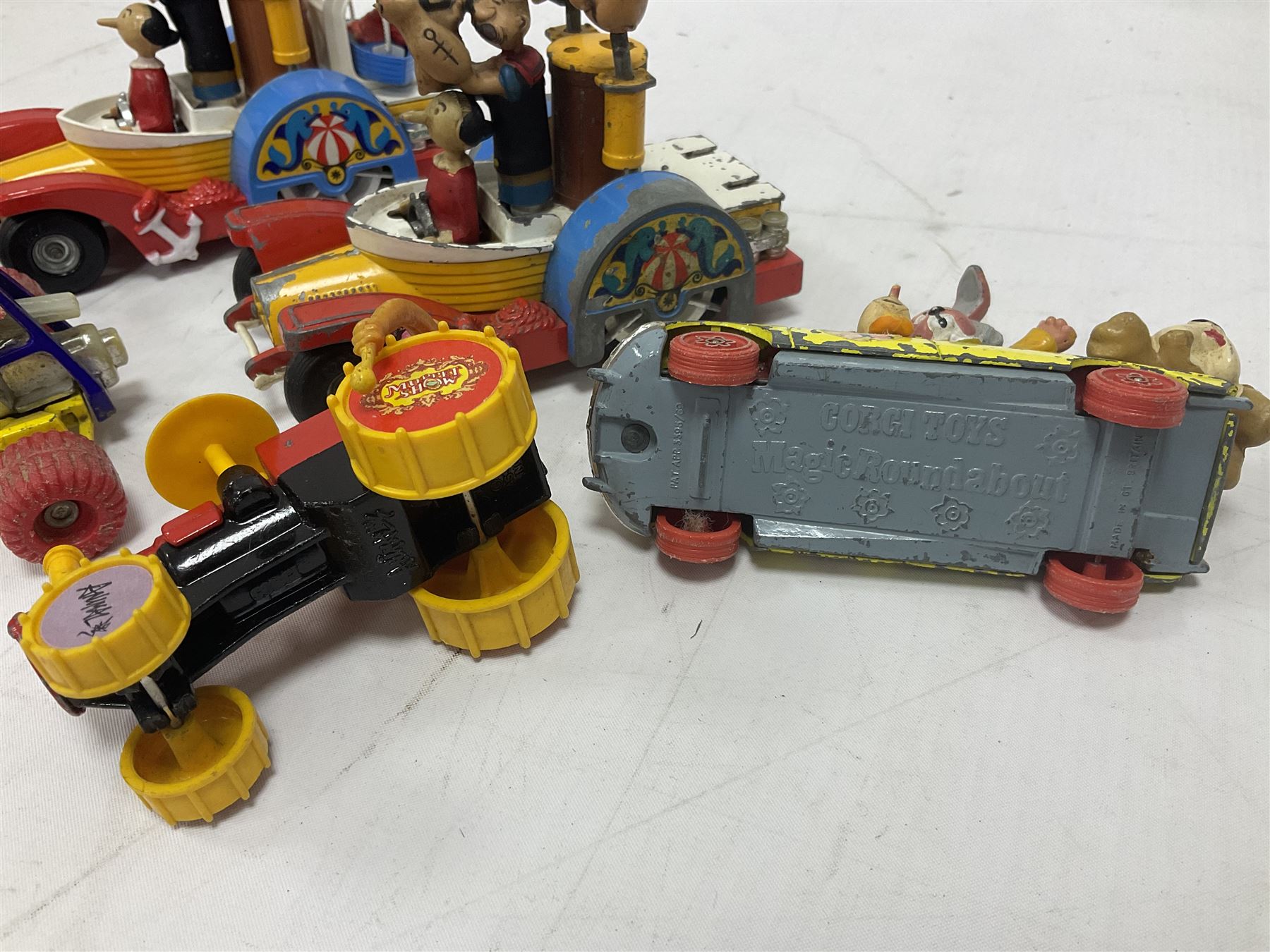Corgi - ten unboxed and playworn TV/Film related die-cast models including three Popeye Paddle Wagons; Dick Dastardly; Magic Roundabout; Muppets; Batman Penguinmobile; and Basil Brush (10)