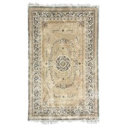 Chinese washed woollen camel ground rug, circular medallion surrounded by scrolls, the border decorated with birds and trailing floral decoration (248cm x 155cm); Chinese washed woollen pale green ground rug (125cm x 69cm); Persian design rug (186cm x 121cm) (3)