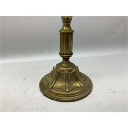 19th century brass oil lamp, the green vaseline glass shade of wrythen and frill form above a clear glass reservoir, raised upon a column with stepped circular base with stylised Art Nouveau motif detail, with clear glass chimney
