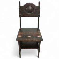 Arts & Crafts oak metamorphic chair, circular panelled back above hinged seat opening into a set of library steps with brass securing straps, circa 1900