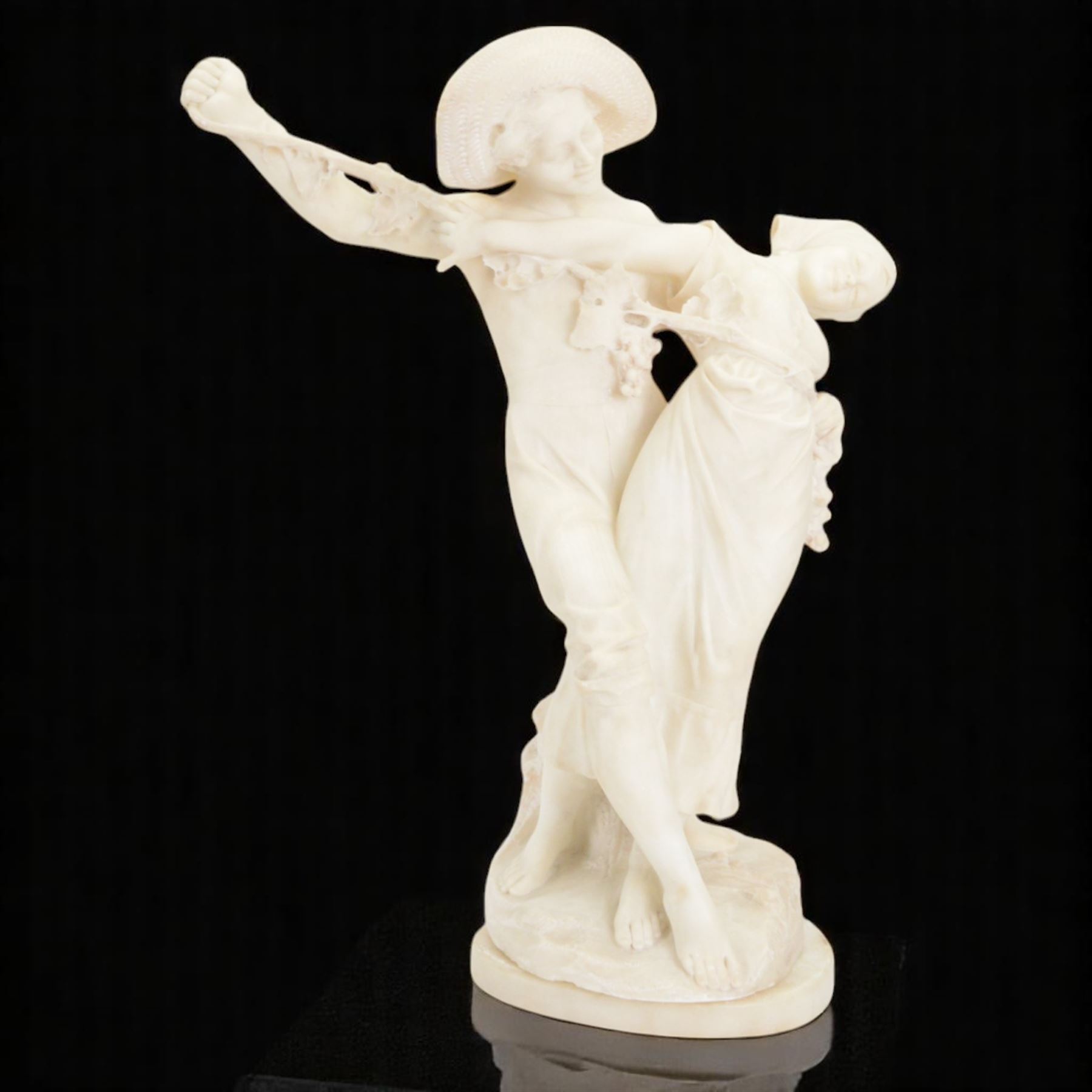 Alabaster bacchanalian figure group, modelled as two youths dancing entwined with a fruiting vine, the separate base signed D E Fiaschi, H58cm