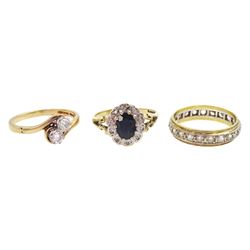 9ct gold two stone round brilliant cut diamond crossover ring, total diamond weight 0.20 carat, 18ct gold paste stone full eternity ring and a 9ct gold sapphire and diamond cluster ring