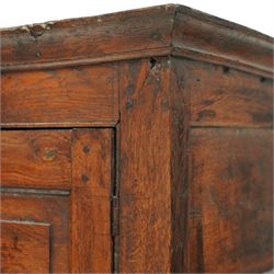 Georgian rustic oak housekeeper’s cupboard, moulded cornice above a pair of fielded panel cupboard doors enclosing a boarded interior with central divider and hanging hooks, the base fitted with two long drawers with brass swan neck handles, raised on stile supports