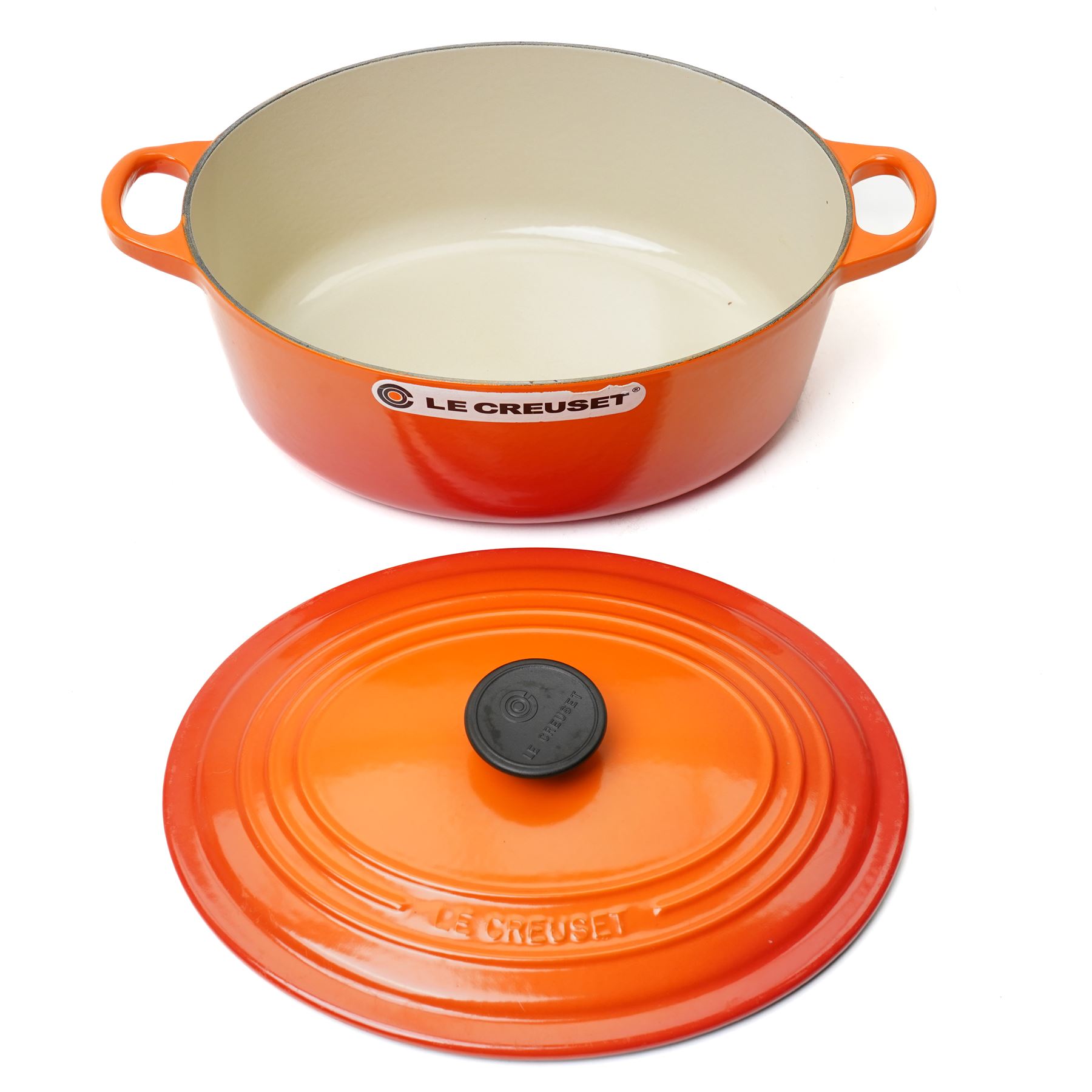 Le Creuset oval casserole dish and cover,  and another shallow example, in the Volcanic colourway