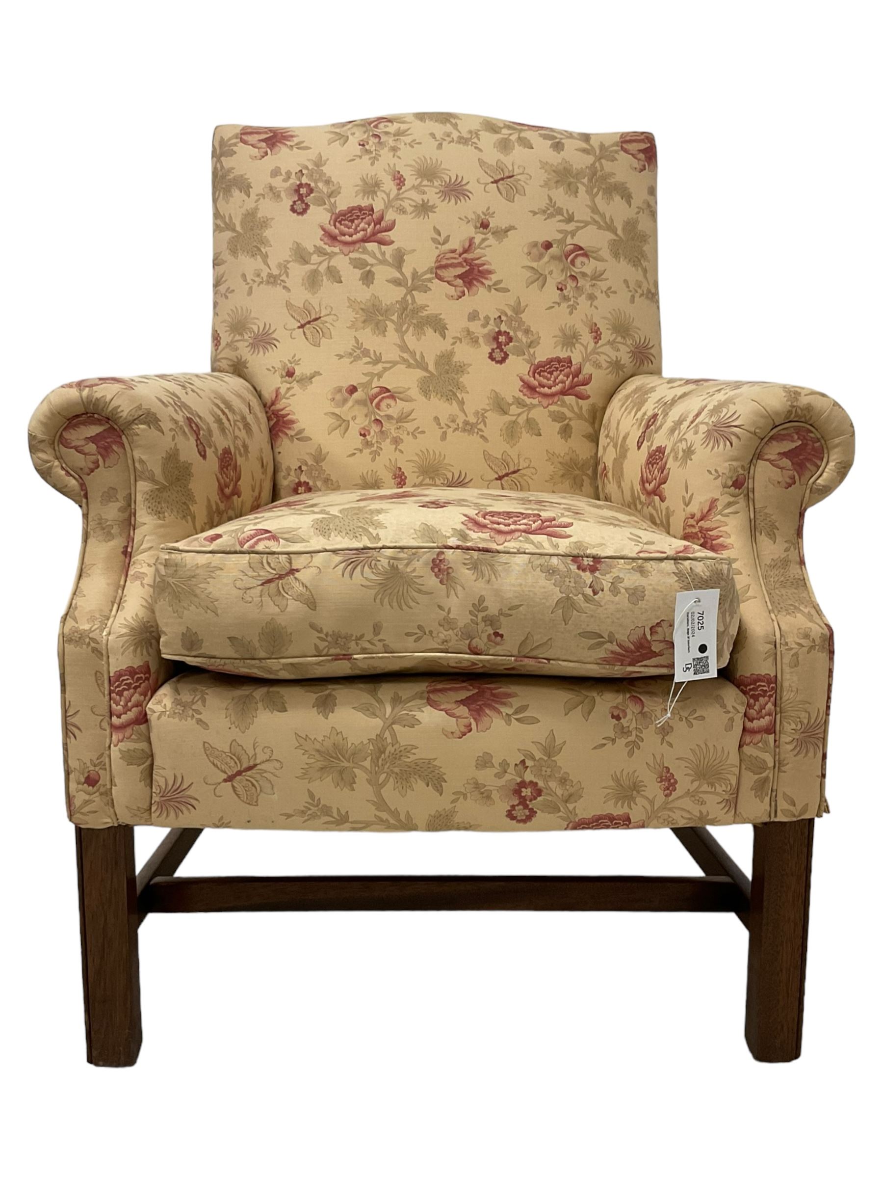 Peter Dudgeon - Georgian design mahogany framed armchair, shaped cresting rail over sprung back and seat flanked by rolled arms, upholstered in floral patterned fabric with matching seat cushion, on square supports joined by stretchers
Provenance: From the Estate of the late Dowager Lady St Oswald