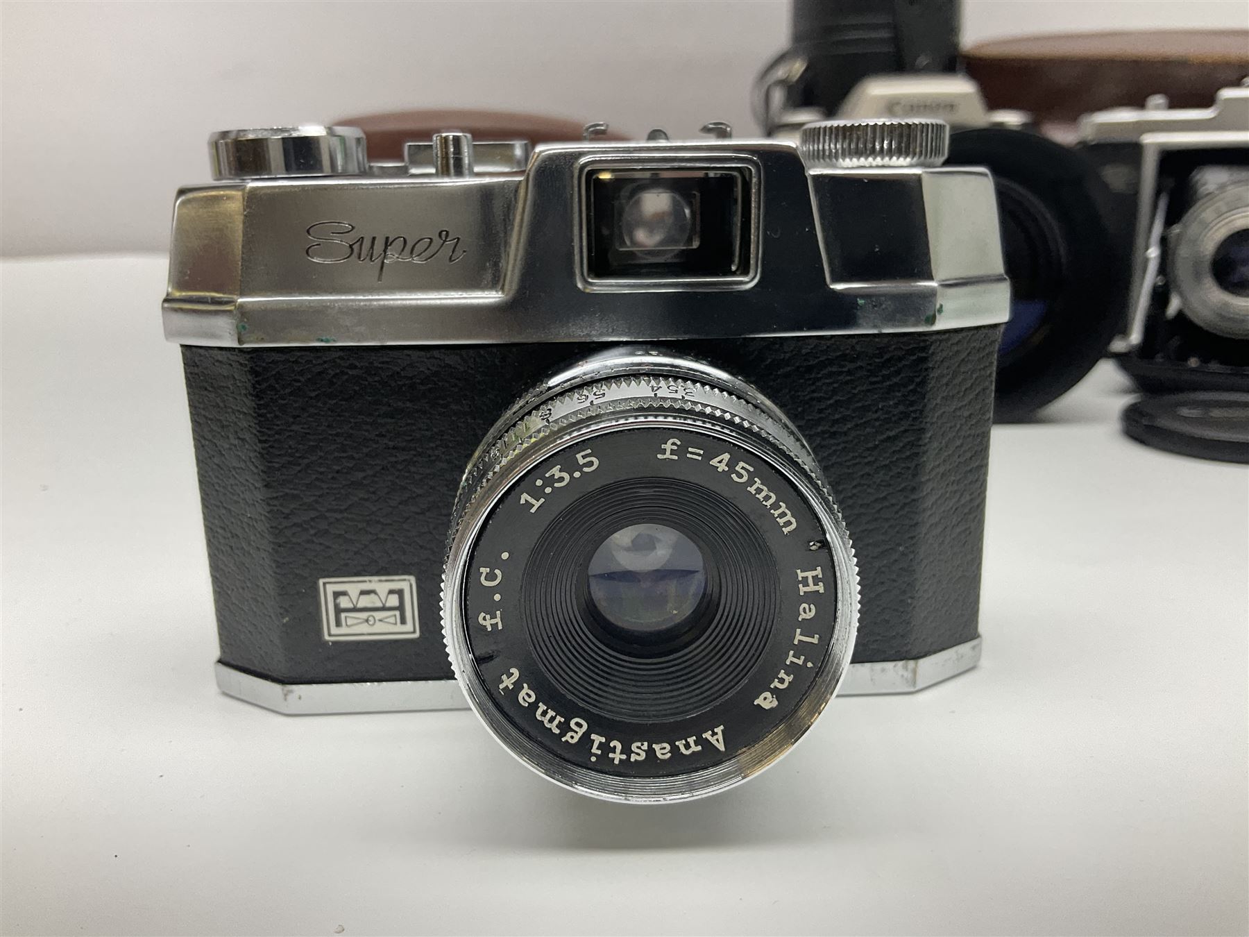 Canon EOS 50e camera body, serial no 8305671 with 'Canon Zoom EF 35-135mm 1:4-5.6' lens together with Halina 35X super camera body, with 'Halina Anastigmat f.c. 1:3.5 f=45mm' lens and other camera equipment 