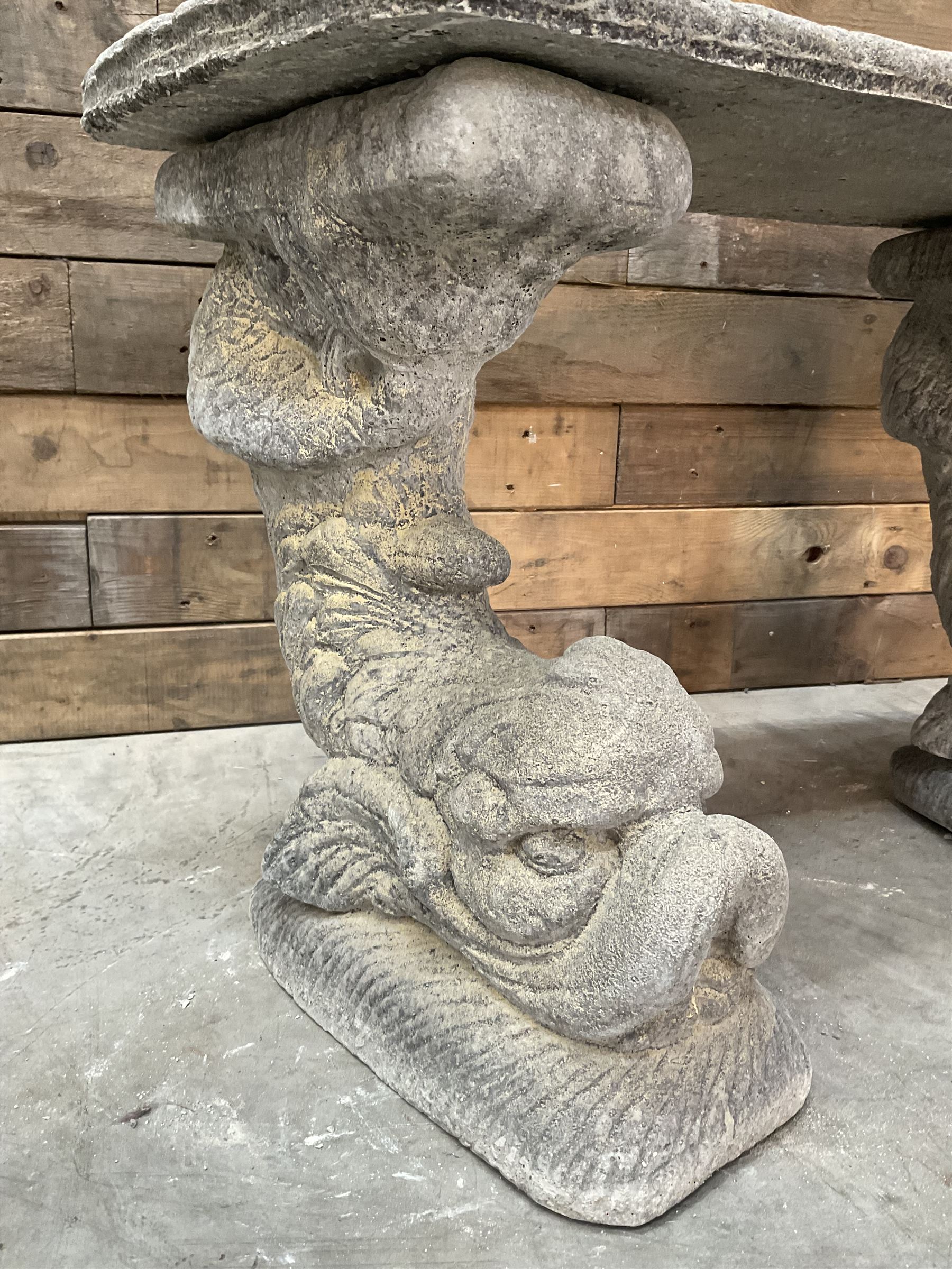 Cast stone four piece curved Dolphin bench, set with three dolphin pillars, curved rectangular slab top with detailed border