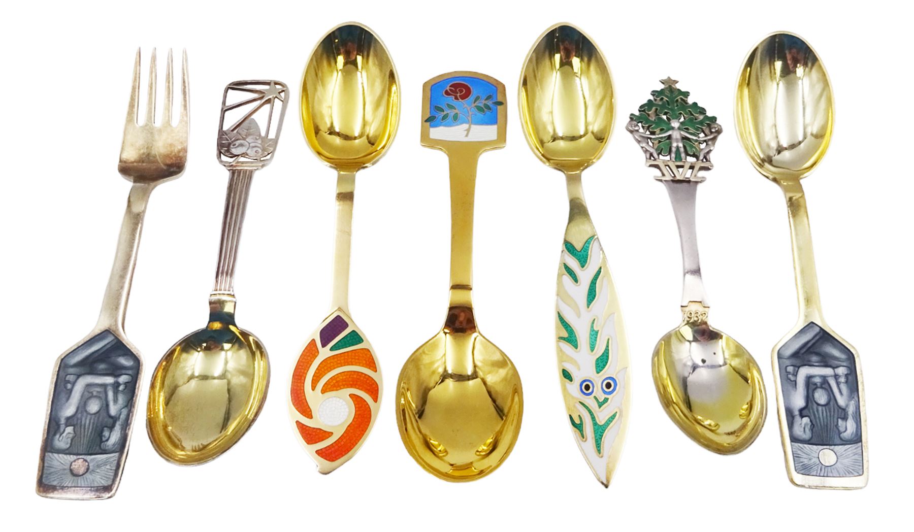 Collection of Danish silver and silver-gilt year spoons by Anton Michelsen, two examples with pierced enamel tree and berry decoration, dated 1932 and 1938, each impressed on underside A.Michelsen Copenhagen, Sterling Denmark, and a further five examples decorated with enamel floral and family designs, dated between 1970 and 1977, each impressed on underside A.Michelsen Sterling Danmark, impressed with varying artist signatures,  approximate gross weight 10.43 ozt (324.3 grams)