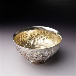 Matched three piece silver tea set comprising teapot of squat circular form London 1827,  milk jug of similar date and sugar bowl with Britannia standard marks, all with later embossed floral decoration and coat of arms, all marks rubbed