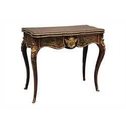  Mid 19th century French ebonised and red boulle card table, baise lined swivel fold over serpentine top with scrolling pierced brass inlay with ormolu bead, the shaped apron with acanthus leaf and mask, on cabriole supports with cherub and floral moulded ormolu mounts, W87cm, H75cm, D44cm  