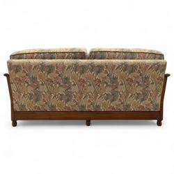 Ercol – bergère four piece suite, including armchair, two seat sofa, three seat sofa and footstool, all with removable floral upholstered cushions, the frames with side caning and rounded arm supports in stained beech

Three seat (H 87cm, D 89cm, W 196cm)
Two seat (H 87cm, D 89cm, W 137cm)
Armchair (H 87cm, D 89cm, W 87cm)
Footstool (H 28cm, D 55cm, W 55cm)