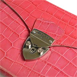 Aspinal of London fuchsia pink crocodile-embossed leather clutch bag with silver-tone shield-shaped clasp engraved Aspinal of London, the flap opening to a beige fabric-lined interior fitted with a zip pocket, slip pocket, integrated mirror and detachable chain shoulder strap, leather brand label stamped Aspinal of London England Fine Leather, accompanied by an Aspinal of London dust bag, W23cm H17cm