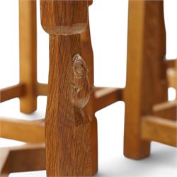 Mouseman - set of six (4+2) oak dining chairs, pierced and carved lattice back over leather upholstered seat, on octagonal front supports united by stretchers, carved with mouse signature, by the workshop of Robert Thompson, Kilburn