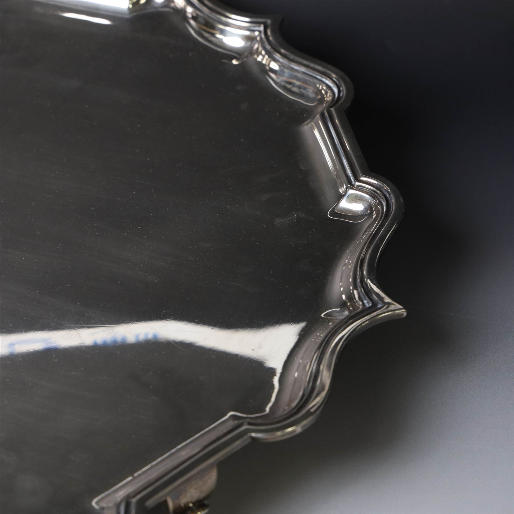 Early 20th century large silver salver, of circular form with Chippendale style rim, upon four hoof feet, hallmarked Elkington & Co Ltd, Birmingham 1918, D47cm