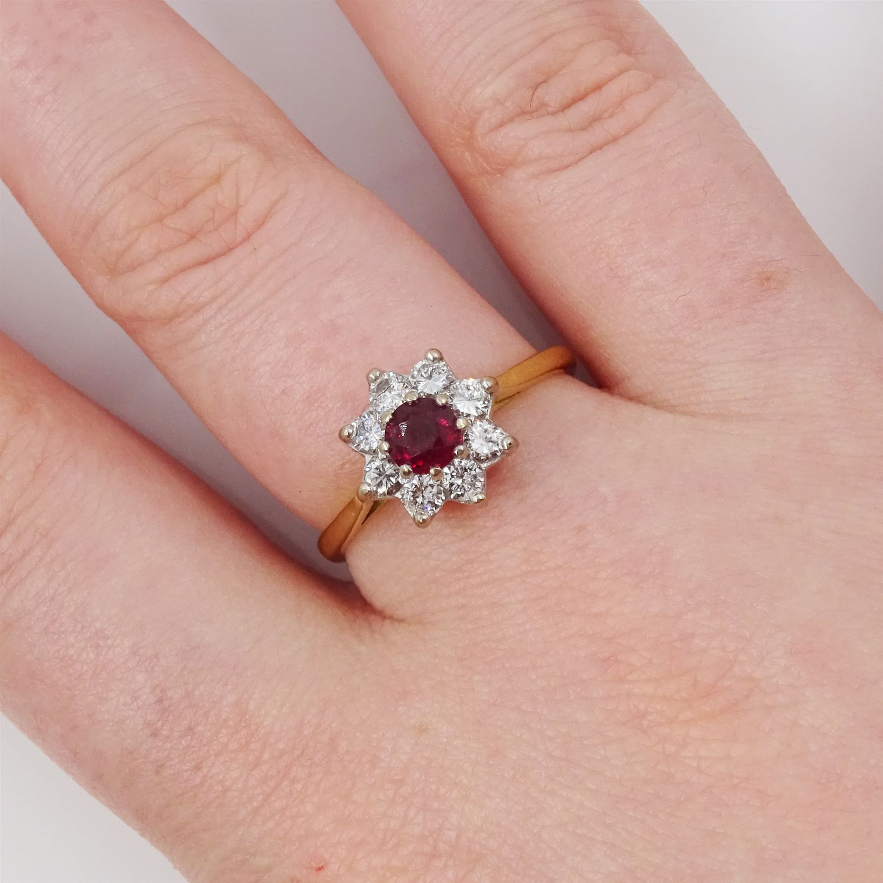 Gold ruby and diamond cluster ring, round cut ruby of approx 0.25 carat, surrounded by eight round brilliant cut diamonds, stamped 18ct, total diamond weight approx 0.40 carat