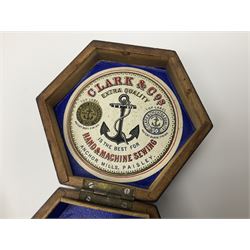 Mauchline ware black lacquered octagonal bobbin box, the hinged cover with forget-me-not floral decoration and sentimental verse, opening to reveal six bobbin holders and retail label for Clark & Co, together with a Mauchline ware sewing box, with floral decoration throughout and verse to hinged cover, a similar black lacquered needle holder and a Mauchline Tartan ware needle holder, largest diameter D11.5cm