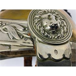 Early 20th century French mounted gendarme's helmet, brass with nickel-silver mountings, broad band embossed with fused grenade, high comb with the face of the gorgon Medusa at the peak and with a black horse hair crest, plume socket at the left, leather-backed nickel-silver chin scales with lion mask mounts.
