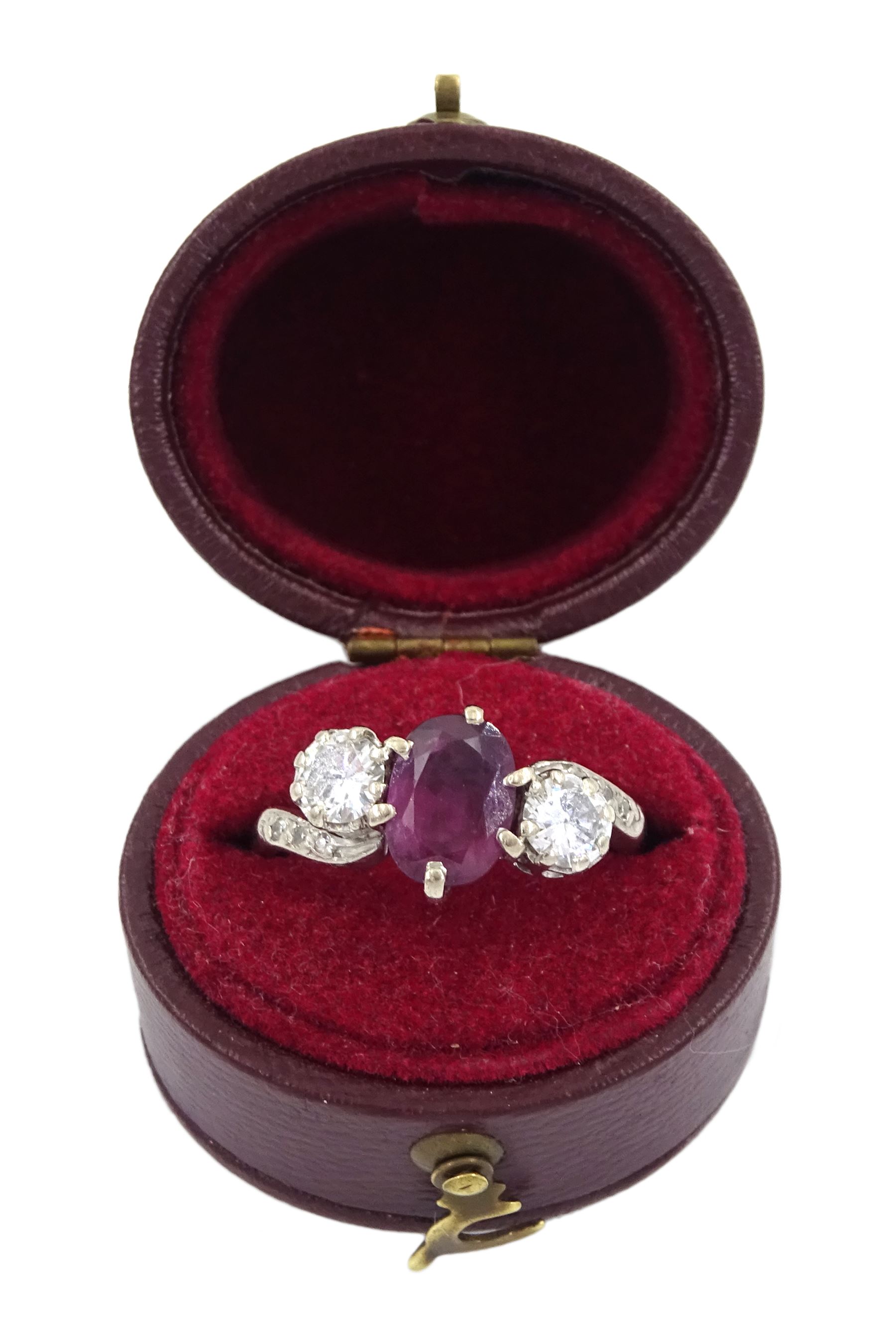 18ct white gold three stone oval ruby and round brilliant cut diamond ring, with diamond set shoulders, stamped, ruby approx 1.15 carat, total diamond weight approx 0.55 carat, in silver top ring box by The Victorian Ring Box Co, Edinburgh 1993 