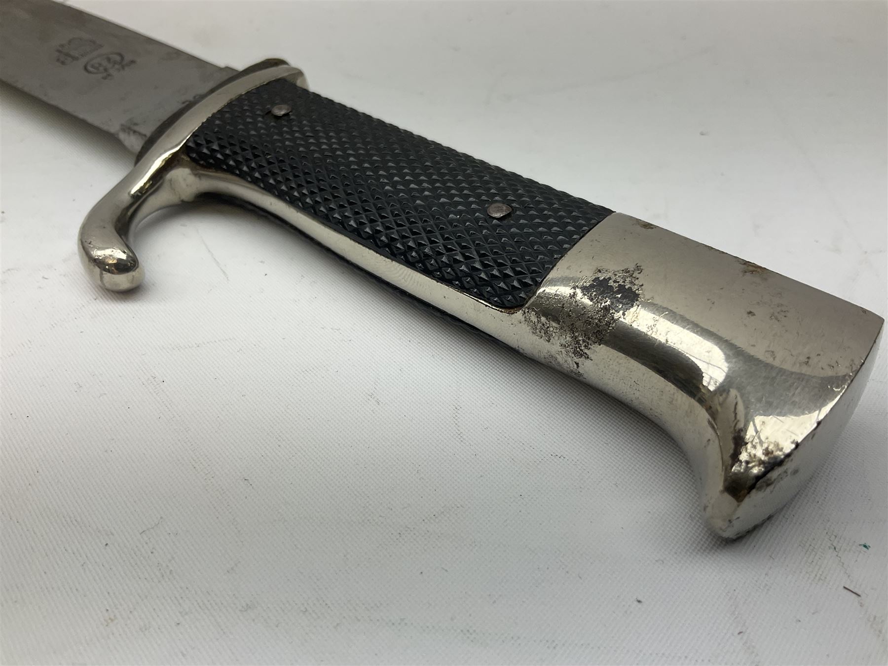 A dagger M 37 for Hitler Youth leaders, with hanger. Maker M7/36, E & F  Hörster, Solingen. Plated blade, the obverse side etched with the motto  Blut und Ehre! (Blood and Honour!).