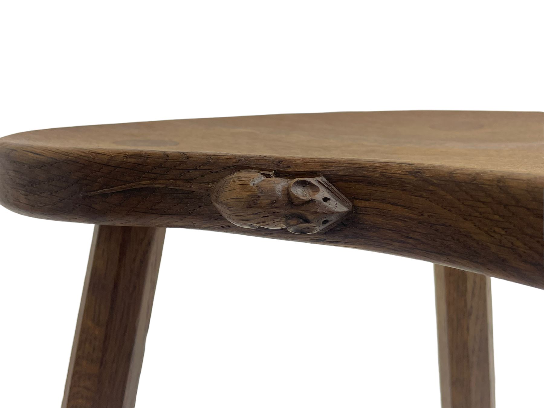 'Mouseman' oak three-legged stool, kidney shaped dished seat carved with mouse signature to edge, by Robert Thomas of Kilburn