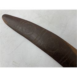 Australian aboriginal woomera spear thrower incised/carved with a wavy line and dots L69cm; and two boomerangs, one with carved geometric decoration (3)
