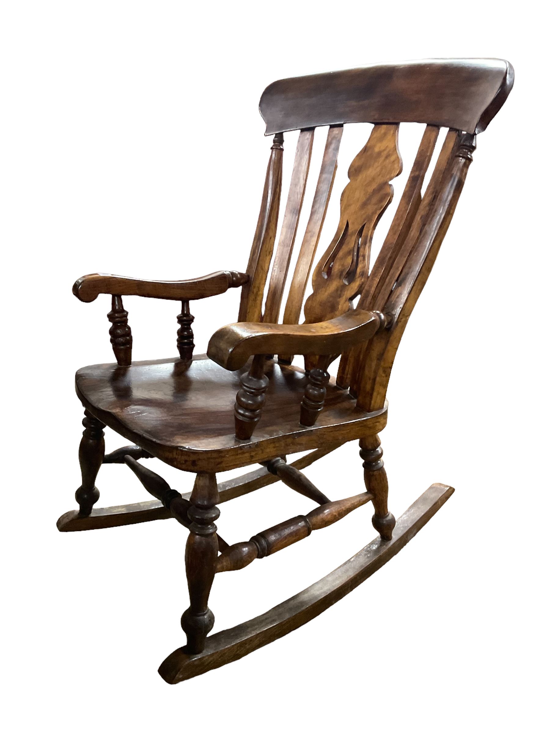 Late 19th century elm and beech farmhouse rocking chair, pierced splat and lath high back over saddle seat with turned supports