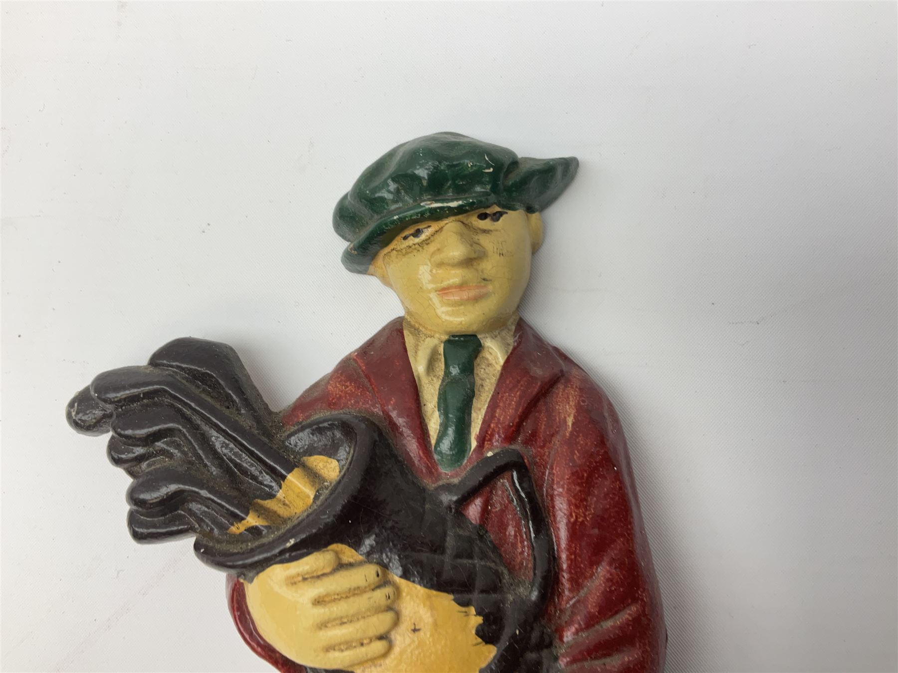 Pair of cast iron Dulux Old English sheepdog doorstops together with another modelled as a golfer