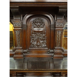  Large Victorian oak sideboard, raised back with bevel edge mirror plates. single shelf above moulded top, with two carved frieze drawers and two similar doors, on turned supports joined by platform stretchers, W218cm, H189cm, D66cm  
