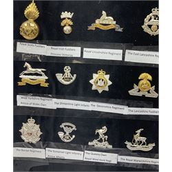Collection of thirty-two reproduction military badges, including Royal Scots Fusiliers, Royal Lincolnshire Regiment, The Boarders Regiment etc. 